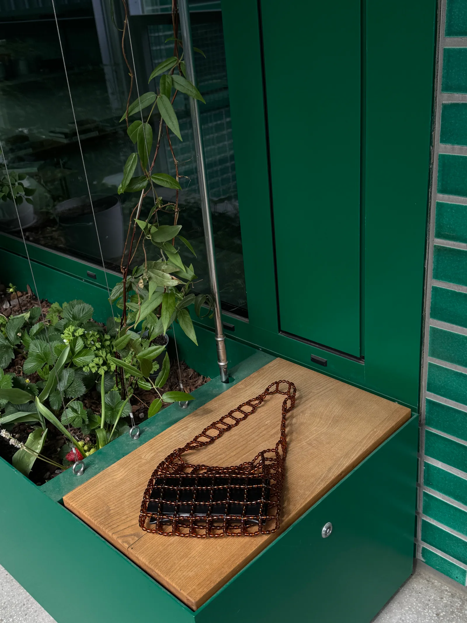 A compact shoulder bag made of interlinked brown beads with a structured, grid-like design. Lightweight yet durable, it fits essentials and adds a clean, modern accent to everyday outfits.

Approx. 22 cm x 17 cm 
Strap length - 31 cm

Brown glass beads
Includes a removable light coloured pouch

We recommend carrying only essentials such as your phone, lipstick, wallet and sunglasses. Since we use metal thread for weaving, we advise avoiding direct contact with water.

Handcrafted in Kyiv
