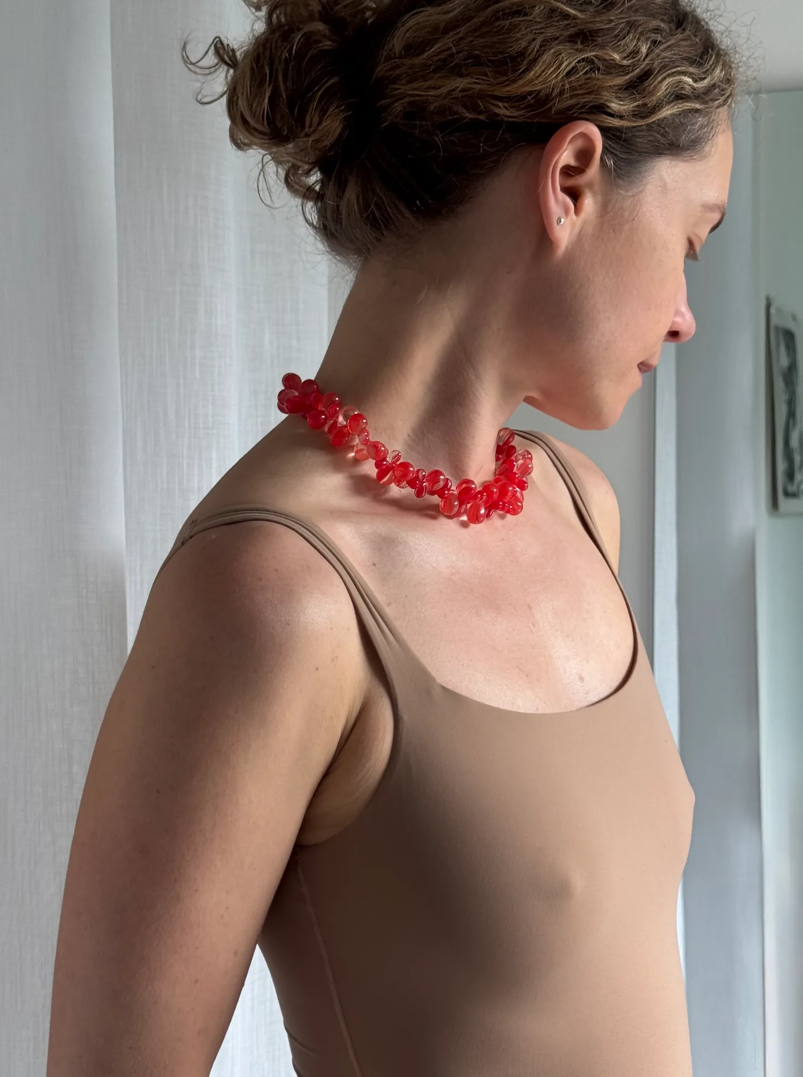 A bold yet delicate statement necklace handcrafted with translucent red glass beads in organic petal-like shapes. Lightweight, playful, and luminous.

Glass beads 
Sterling silver hardware

43 cm length

Each piece is uniquely arranged, so the necklace may vary slightly from the one pictured.

Handcrafted in Berlin