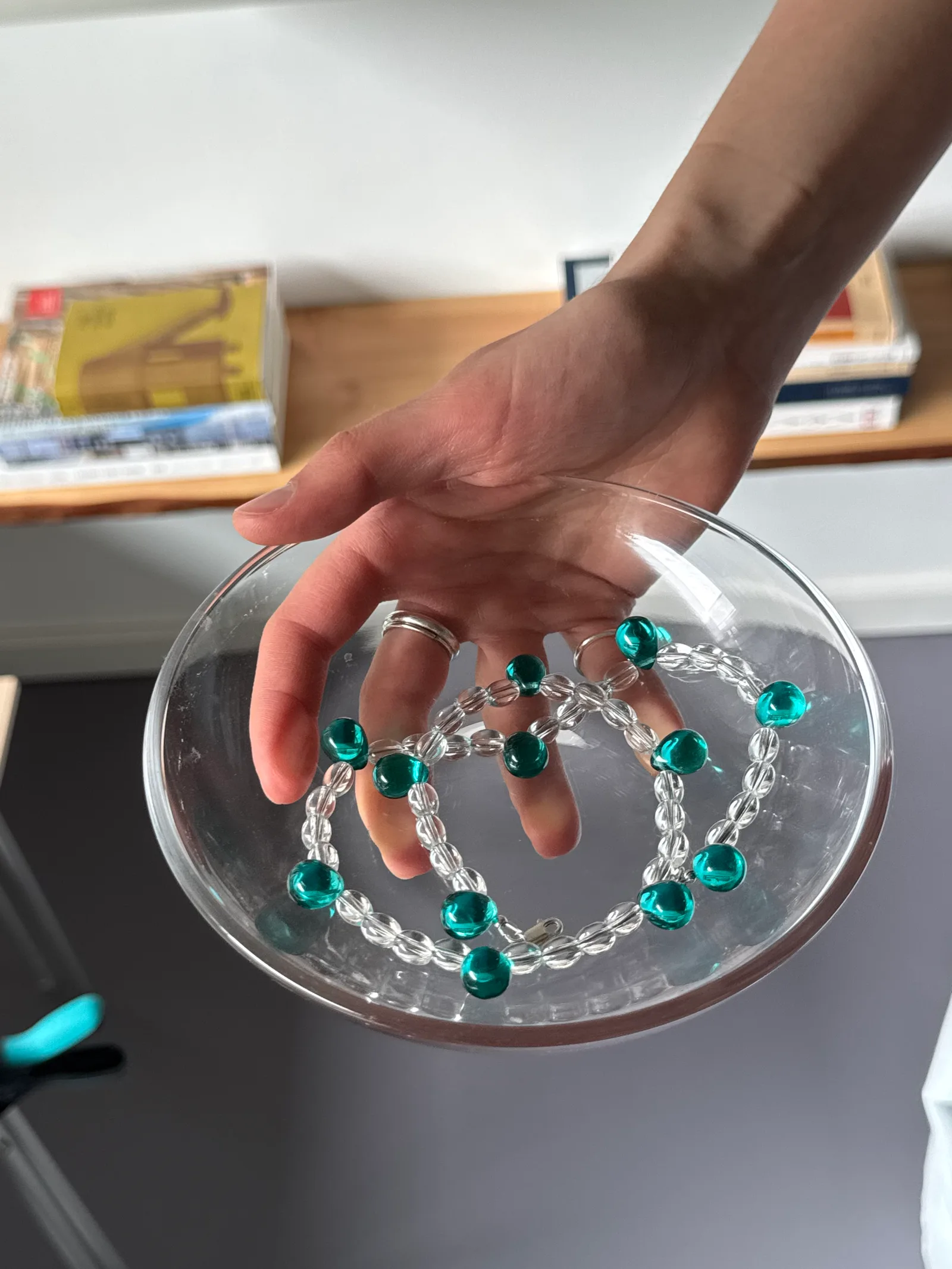 A short necklace made of clear, transparent beads accented with small colorful drops. The beads are arranged in a layered, sculptural pattern that catches the light with every movement. 

Glass beads 
Sterling silver hardware

47 cm length

Handcrafted in Berlin