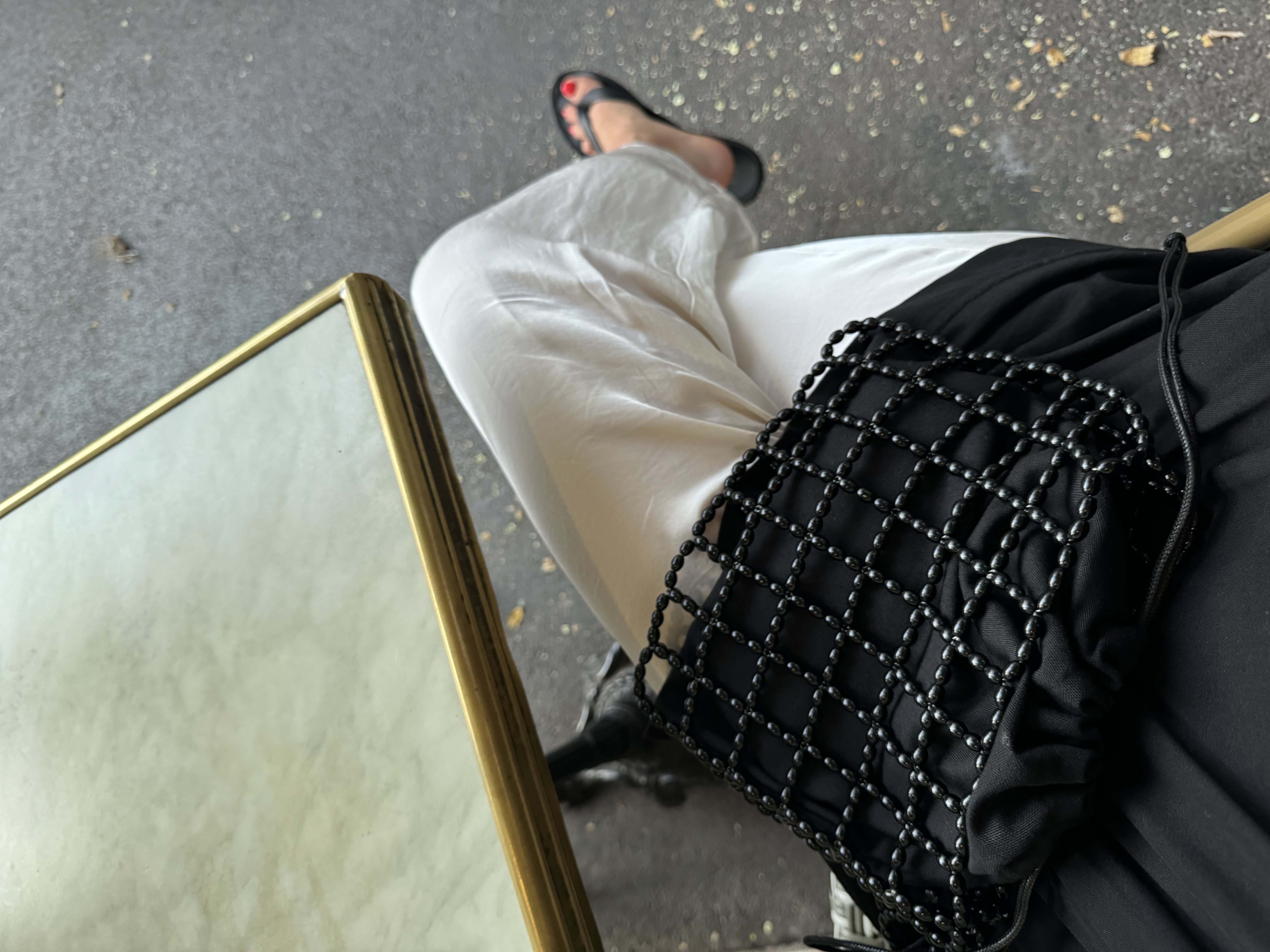 A compact shoulder bag made of interlinked black beads with a structured, grid-like design. Lightweight yet durable, it fits essentials and adds a clean, modern accent to everyday outfits.

Approx. 21 cm x 17 cm
Strap length - 28 cm

Black glass beads
Includes a removable black cotton pouch

We recommend carrying only essentials such as your phone, lipstick, wallet and sunglasses. Since we use metal thread for weaving, we advise avoiding direct contact with water.

Handcrafted in Kyiv

