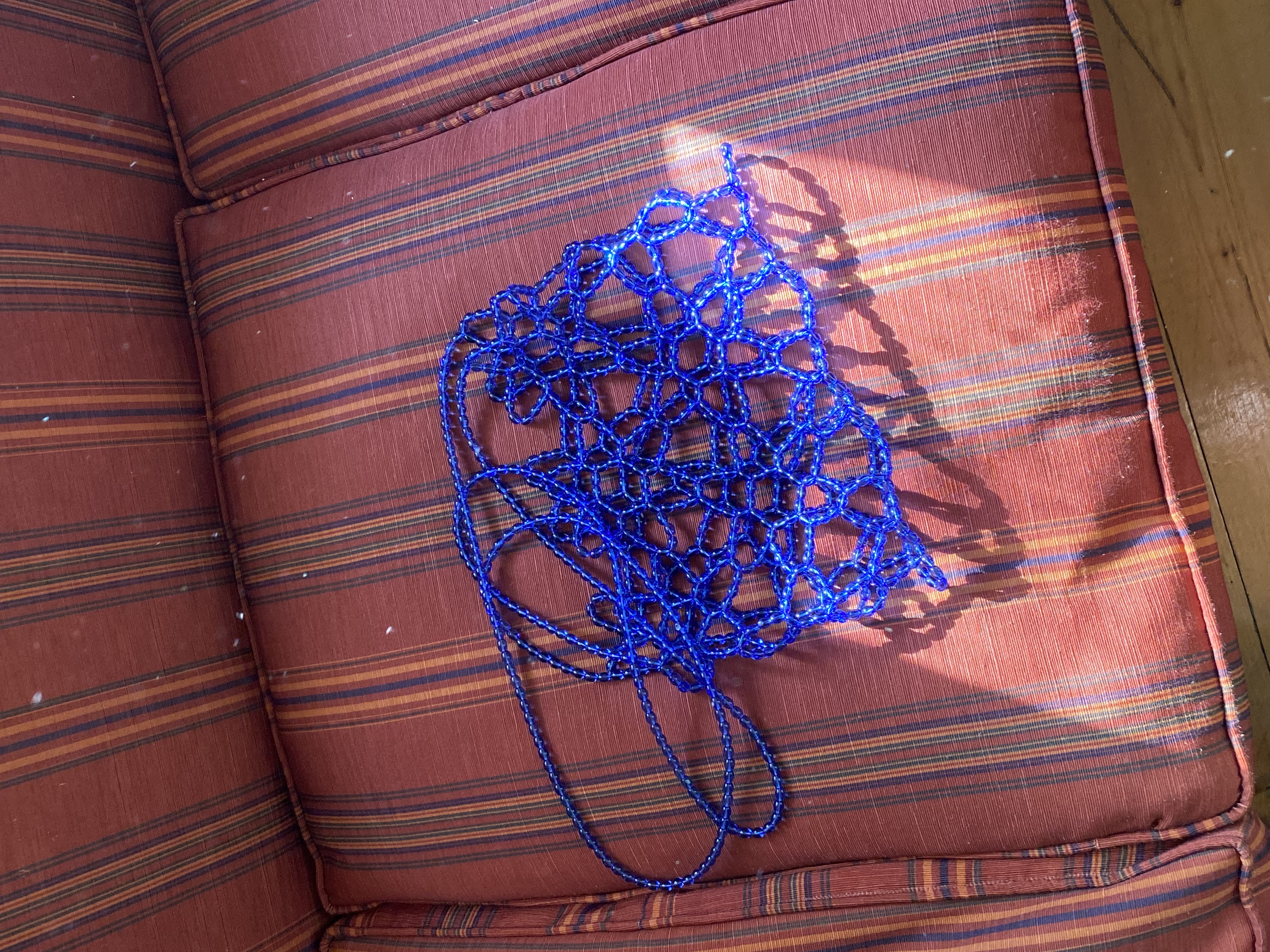 Blue beaded bag with a structured net design and a long shoulder strap. Lightweight and see-through, suitable for carrying small essentials and styling over outfits.

Approx. 28 cm x 19 cm 
Strap length - 43 cm

Blue glass beads
Includes a removable light coloured pouch

We recommend carrying only essentials such as your phone, lipstick, wallet and sunglasses. Since we use metal thread for weaving, we advise avoiding direct contact with water.

Handcrafted in Kyiv
