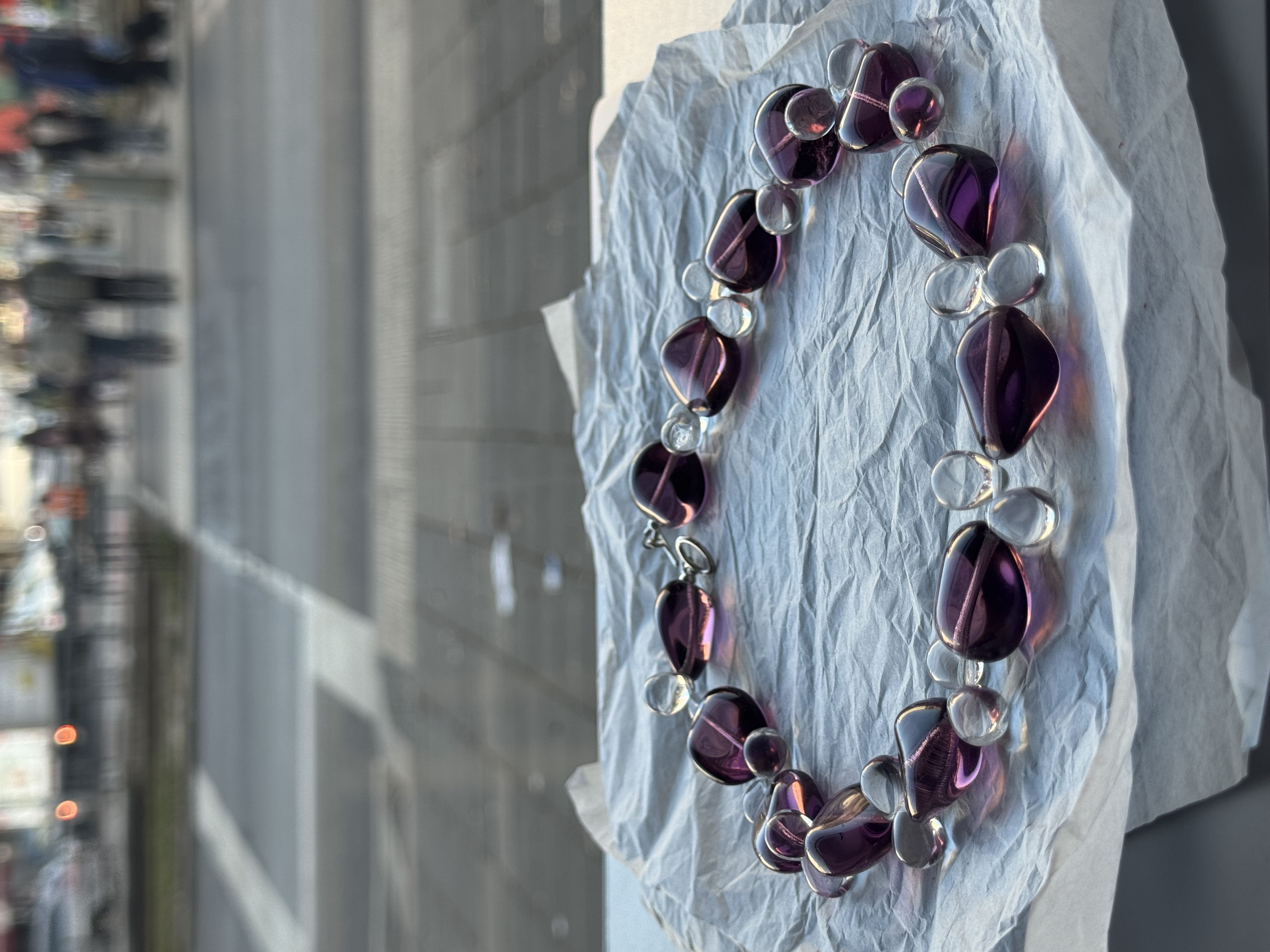 The necklace features a harmonious composition of oval glass beads in rich plum tones, accented with smaller transparent elements

Glass beads 
Sterling silver hardware

44 cm length

Handcrafted in Berlin