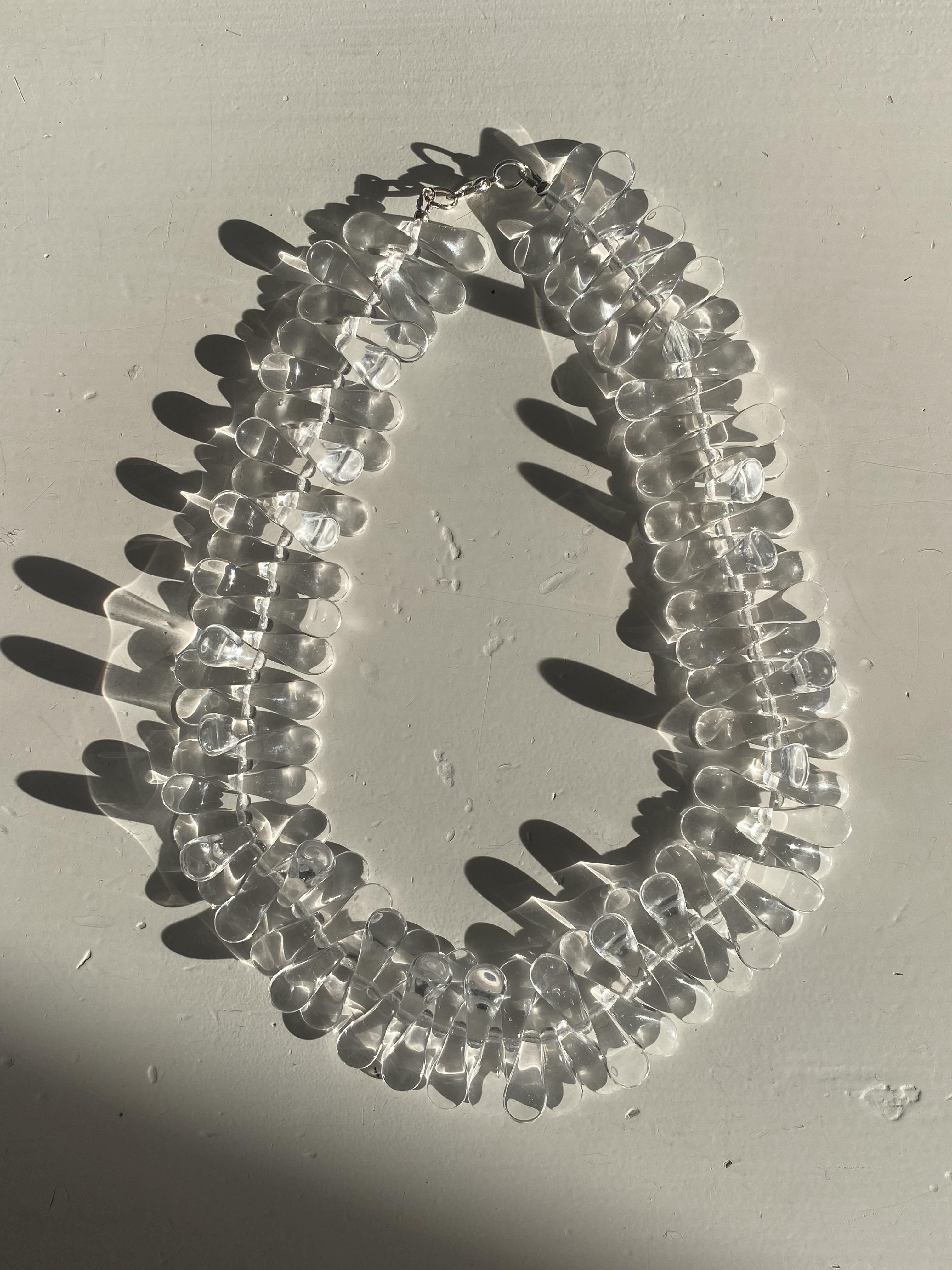 A delicate statement necklace made of translucent beads that softly catch the light

Glass beads 
Sterling silver hardware

47 cm length

Handcrafted in Berlin