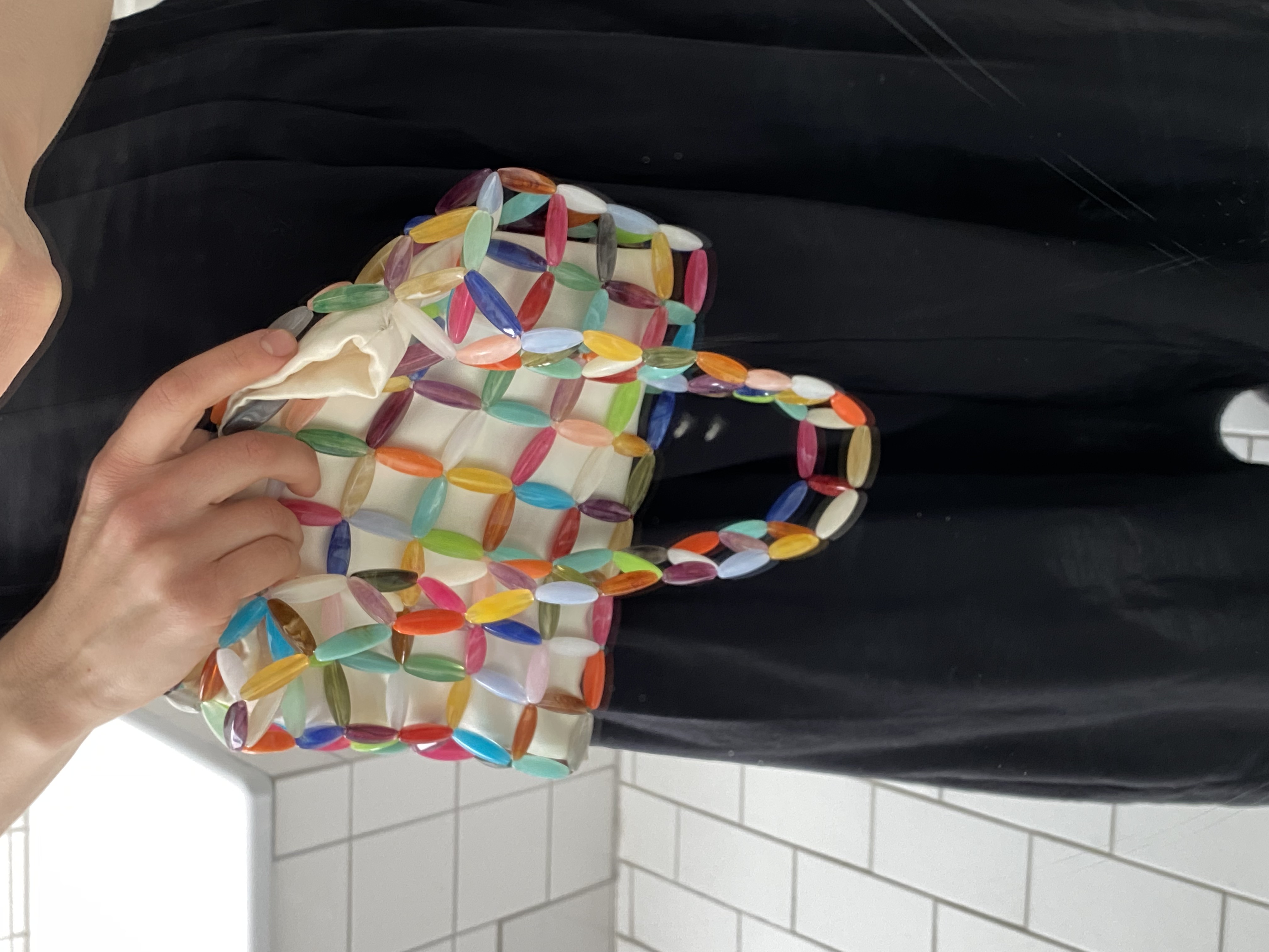 A small shoulder bag handcrafted from multicolored beads with a structured, woven design. Finished with a soft fabric lining, it securely holds essentials while adding a bright, modern touch to everyday looks.
Approx. 24 cm x 19 cm
Strap length - 28 cm
We recommend carrying only essentials such as your phone, lipstick, wallet and sunglasses.
Acrylic beads
Includes a removable light coloured pouch
Each bag is made from a mix of beads, so color combinations may vary slightly from piece to piece.
Handcrafted in Kyiv