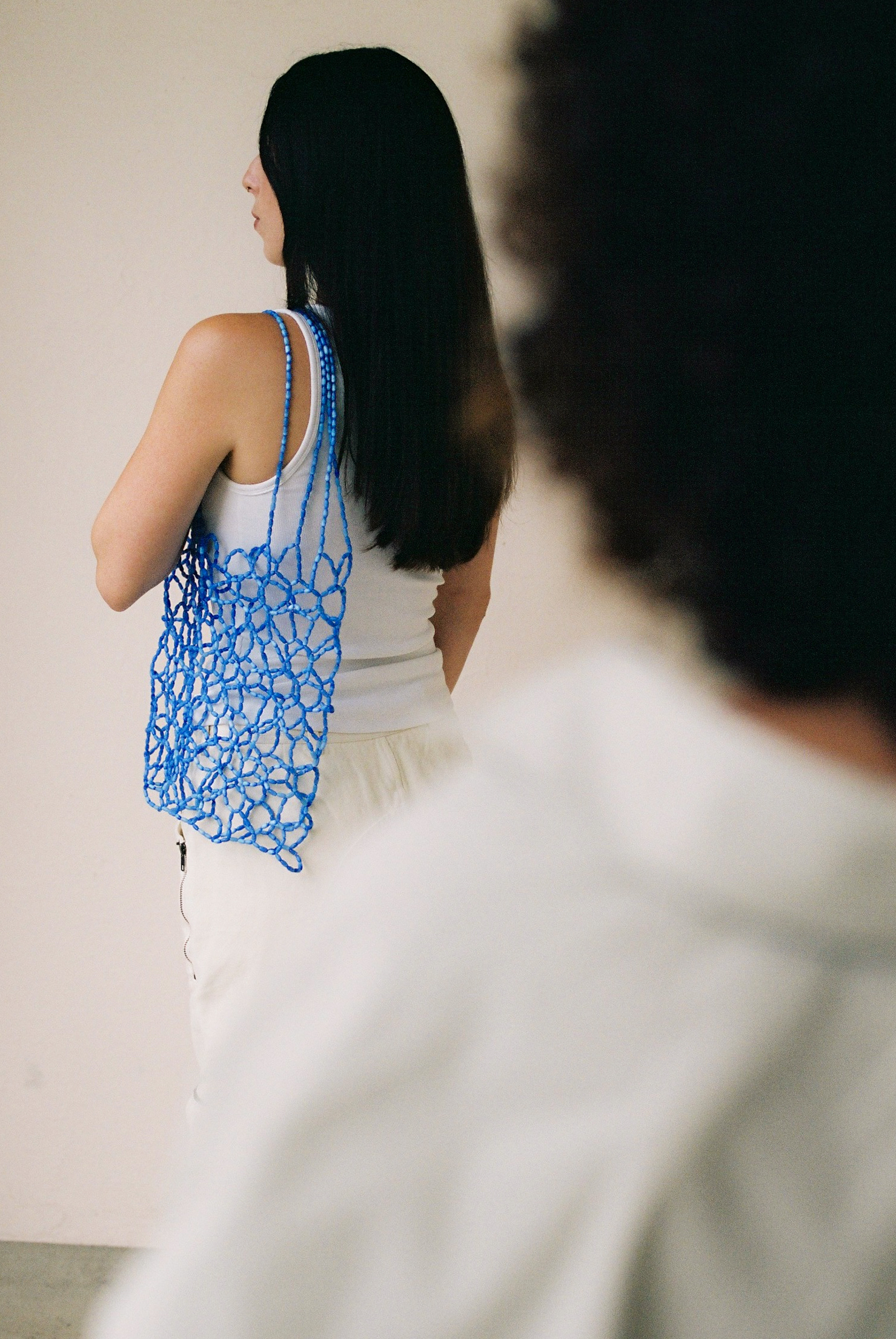 A lightweight net bag handcrafted from blue beads with a flexible, open structure. Designed to be worn over the shoulder, it comfortably carries essentials and works well for summer or casual styling.
Approx. 31 cm x 31 cm
Strap length - 24 cm
Cat eye stones (glass beads with shimmering effect)
Includes a removable light coloured pouch
We recommend carrying only essentials such as your phone, lipstick, wallet and sunglasses. Since we use metal thread for weaving, we advise avoiding direct contact with water.
Handcrafted in Kyiv
